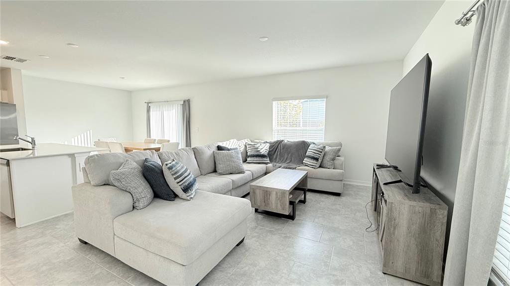 1179 Tyler Loop Lake Wales, FL 33859 - Photo 6 of 25 a living room with furniture window and a flat screen tv