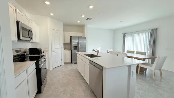 a kitchen with a sink and stainless steel appliances