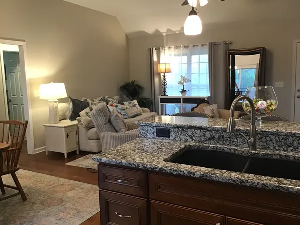 a living room with furniture and a large mirror