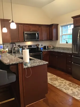a kitchen with a stove a sink and a microwave