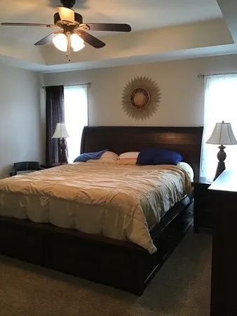 a bedroom with a bed and a chandelier