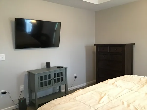 a bedroom with a bed and a flat screen tv