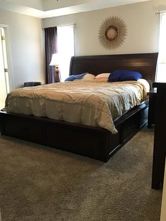 a bedroom with a bed and window