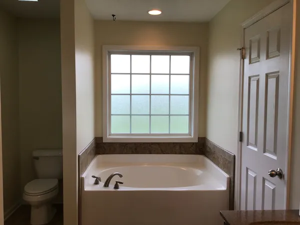 a bathroom with a bathtub and a window