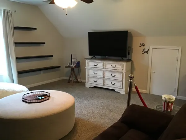 a bedroom with furniture and a flat screen tv