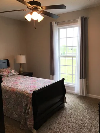 a bedroom with a bed and a window