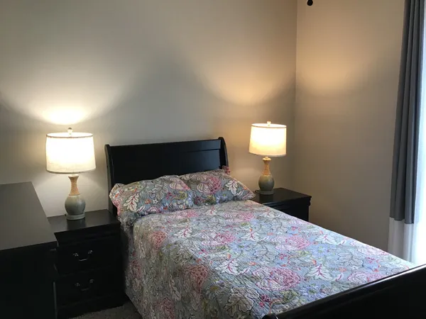 a bedroom with a bed and a chandelier