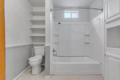 a bathroom with a toilet and a bathtub
