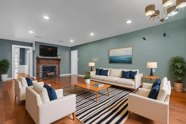a living room with fireplace furniture and a flat screen tv