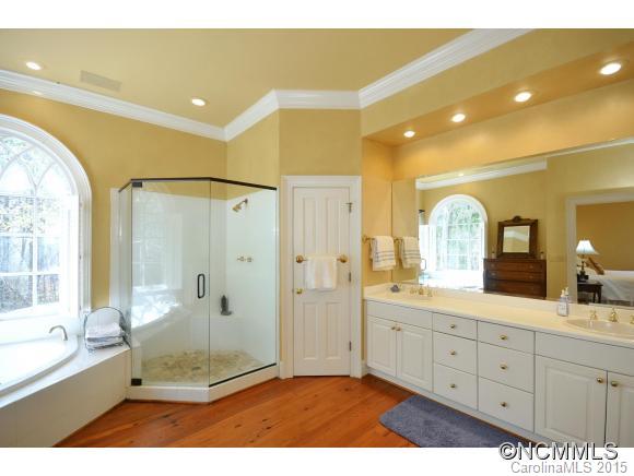 185 Yelton Road, Unit 47 Rutherfordton, NC 28139 - Photo 14 of 19 a bathroom with a double vanity sink toilet a large mirror and shower