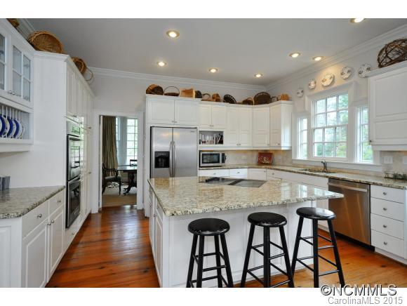 185 Yelton Road, Unit 47 Rutherfordton, NC 28139 - Photo 3 of 19 a kitchen with kitchen island granite countertop wooden cabinets and refrigerator