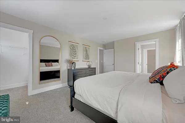 a bedroom with a bed and a dresser
