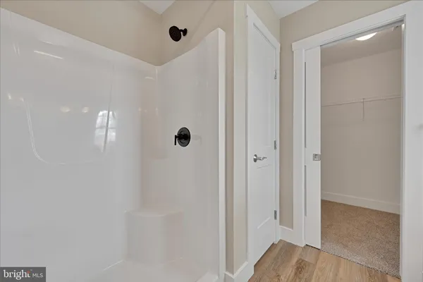 a view of a bathroom with a glass shower door