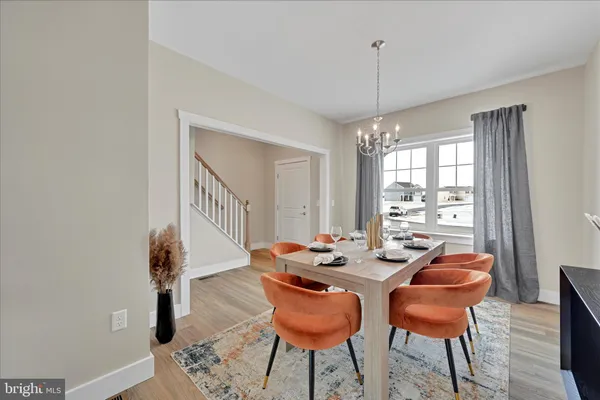 a dining room with furniture and wooden floor