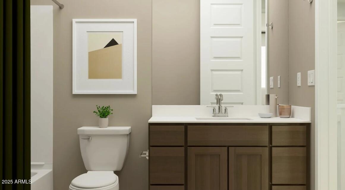 16386 West Weeping Willow Road Surprise, AZ 85387 - Photo 15 of 22 a bathroom with a toilet sink and mirror