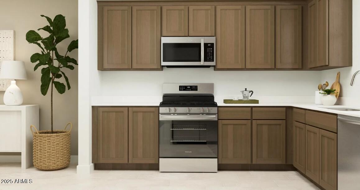16386 West Weeping Willow Road Surprise, AZ 85387 - Photo 2 of 22 a kitchen with stainless steel appliances granite countertop a refrigerator and a stove top oven