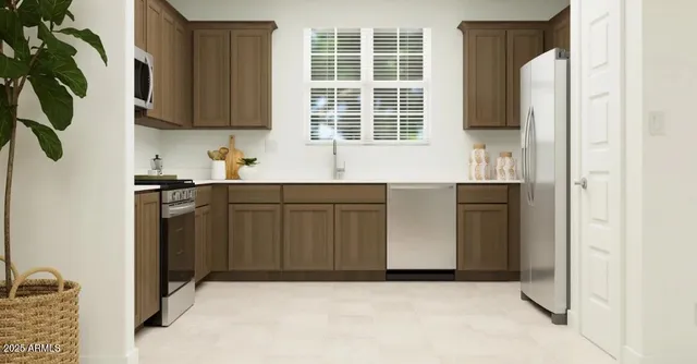 a kitchen with stainless steel appliances granite countertop a refrigerator and a stove top oven