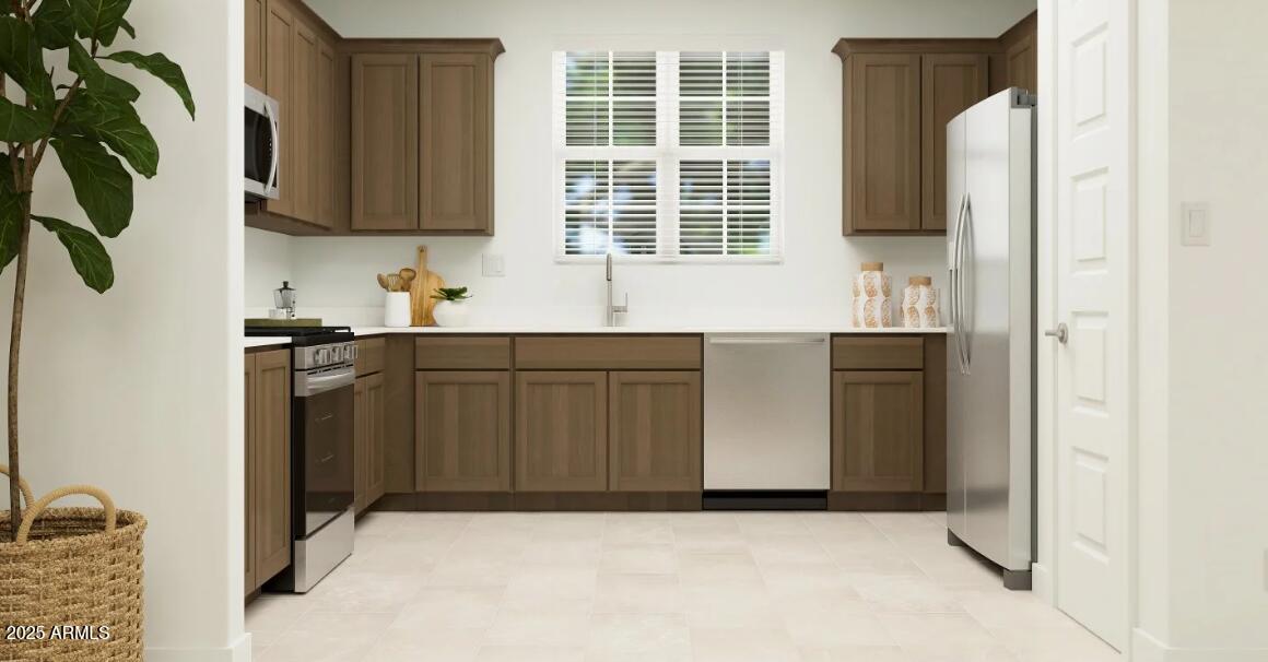 16386 West Weeping Willow Road Surprise, AZ 85387 - Photo 3 of 22 a kitchen with stainless steel appliances granite countertop a sink and a refrigerator