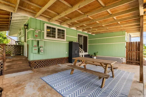 a roof deck with a table and chairs