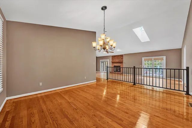 a kitchen with stainless steel appliances granite countertop a refrigerator a stove and a sink