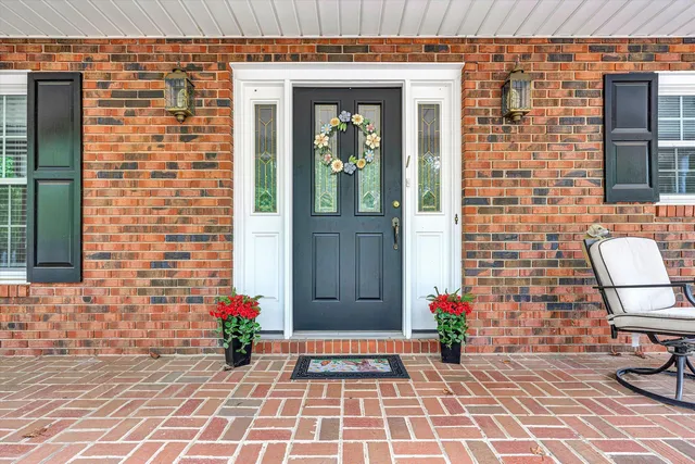 a view of a brick house with a yard