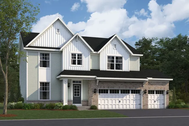 a view of white house with a yard and potted plants