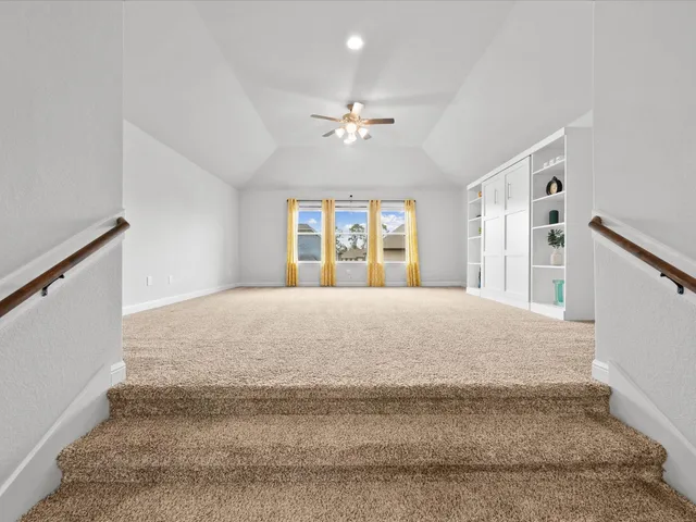 a view of a dining room with furniture a rug and wooden floor