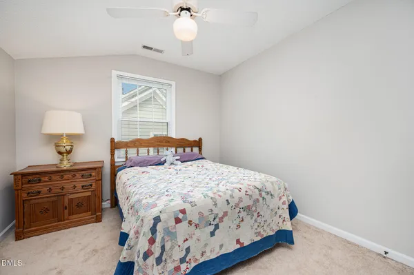 a bedroom with a bed dresser and a window