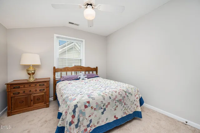 a bedroom with a bed dresser and a window