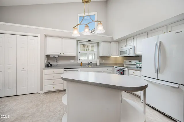 a kitchen with stainless steel appliances a stove a sink island and refrigerator