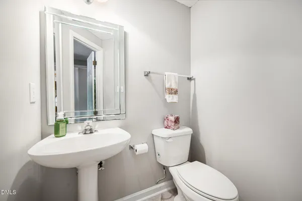a bathroom with a sink a toilet and mirror