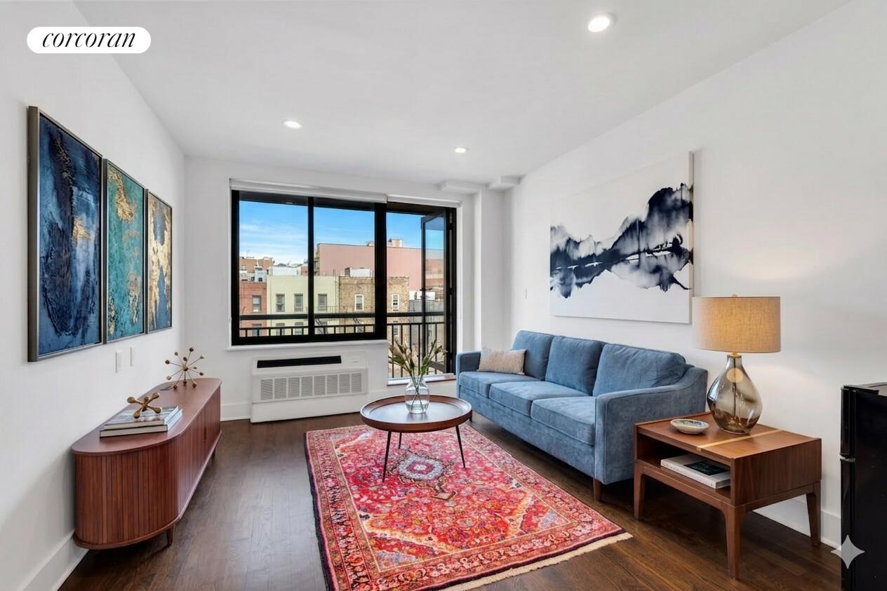 a living room with furniture and a large window