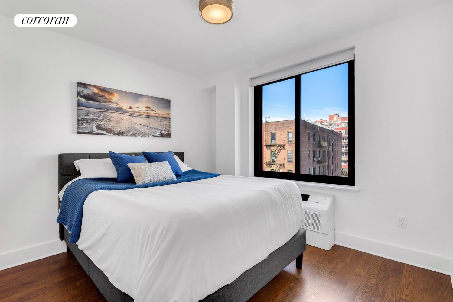 23-33 31st Road, Unit 4D Queens, NY 11106 - Photo 2 of 6 a bedroom with a bed and a window