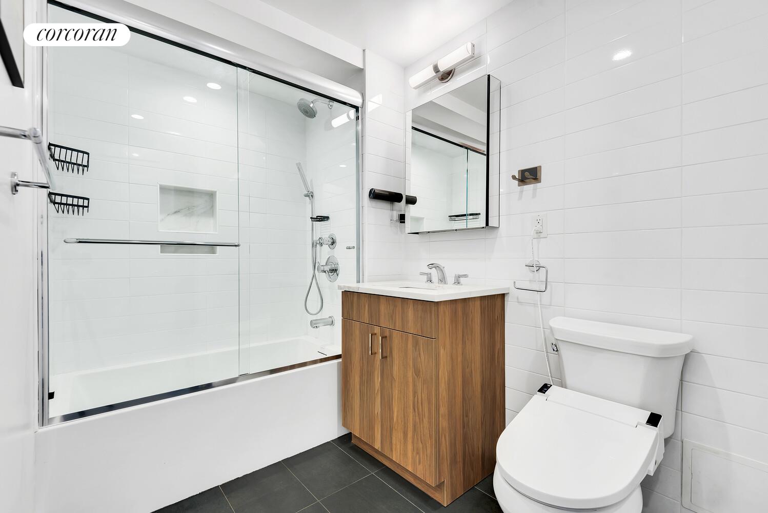 23-33 31st Road, Unit 4D Queens, NY 11106 - Photo 4 of 6 a bathroom with a sink a toilet and shower