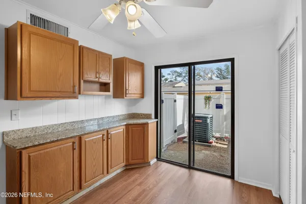 a kitchen with stainless steel appliances granite countertop cabinets and wooden floor