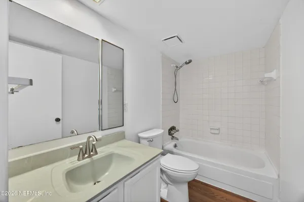 a bathroom with a bathtub shower sink and toilet