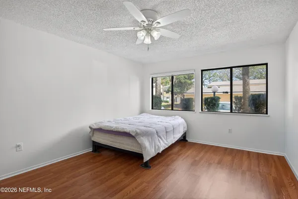 a spacious bedroom with a bed and a large window with outer view
