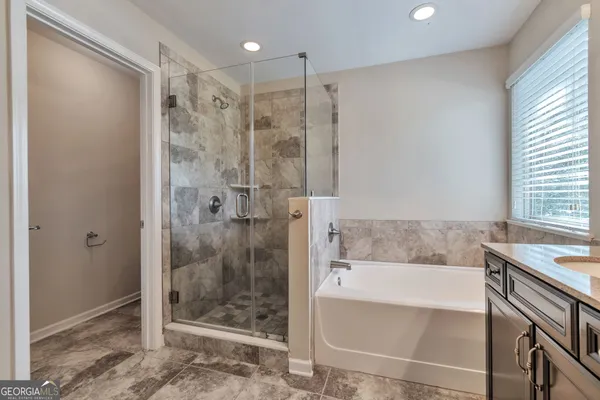 a bathroom with a shower and a bathtub