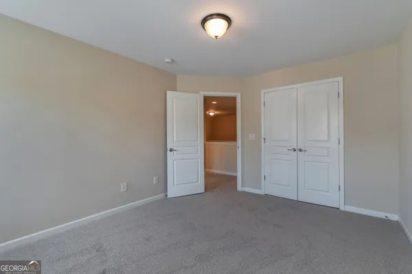 an empty room with closet area