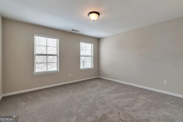 an empty room with closet area