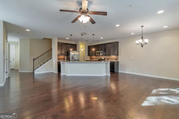 a view of a kitchen with a sink and a refrigerator