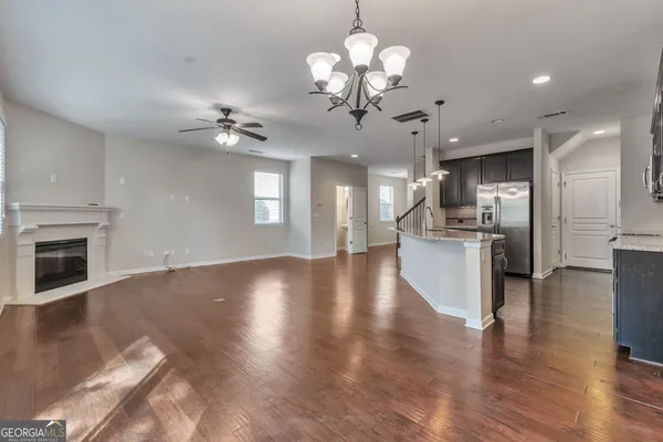 a view of a kitchen with a sink a refrigerator and a fireplace