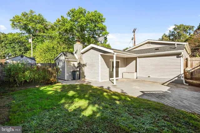 a view of swimming pool with a patio and a garden