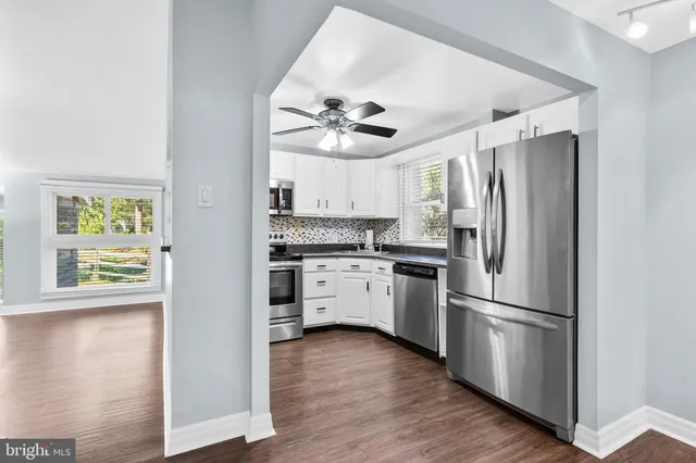 a kitchen with stainless steel appliances granite countertop a stove a refrigerator and a microwave
