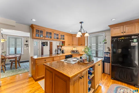 a kitchen with stainless steel appliances granite countertop a stove refrigerator and cabinets
