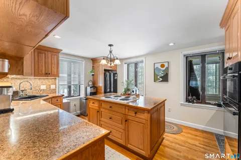 a large kitchen with kitchen island granite countertop a large counter top appliances and cabinets