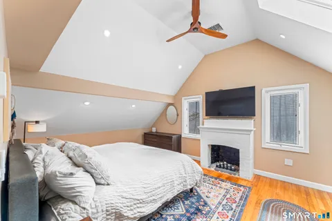 a bedroom with a bed and a fireplace