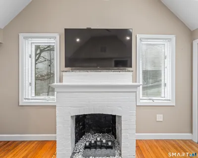 a living room with a fireplace and a flat screen tv