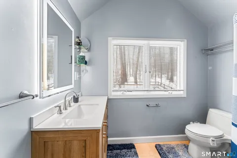 a bathroom with a sink vanity and a mirror
