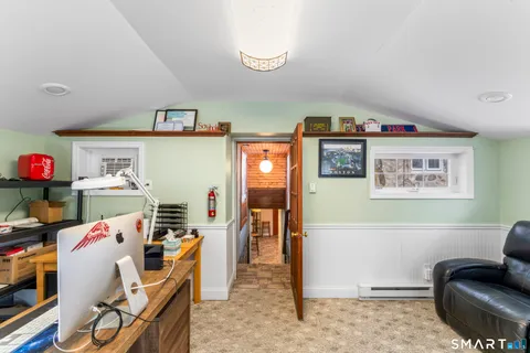 a view of large house with a yard covered in snow